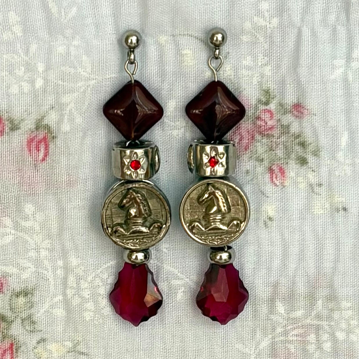 the game’s over. this earring pair takes the cake. inspired partly by medieval battlefields; wit, strategy, wrath. featuring vintage chess piece buttons, swarovski crystal drops, and stainless steel hardware.