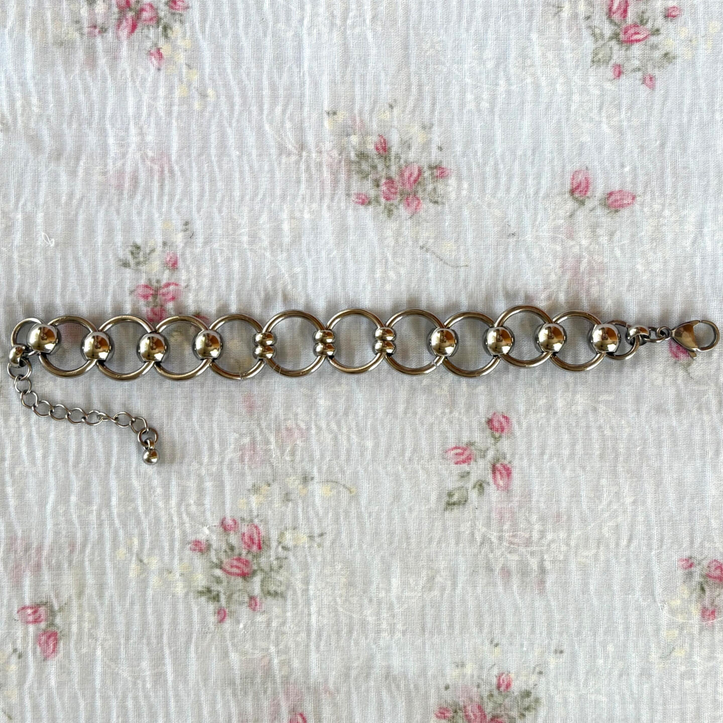 your first step into a world unknown. this bracelet takes inspiration from wrought iron, chainmaille garments, and gothic architecture. constructed using stainless steel beads + hardware.